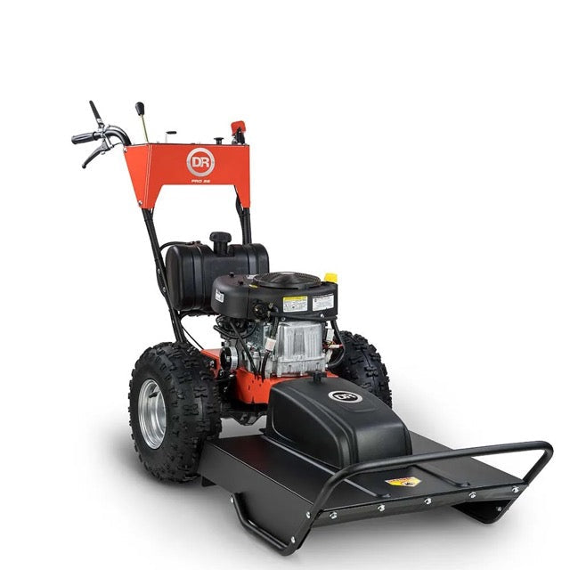 Pillowle DR Power Pro brush mower with 15.5 HP engine cutting through dense grass and thick brush in a lush outdoor setting.