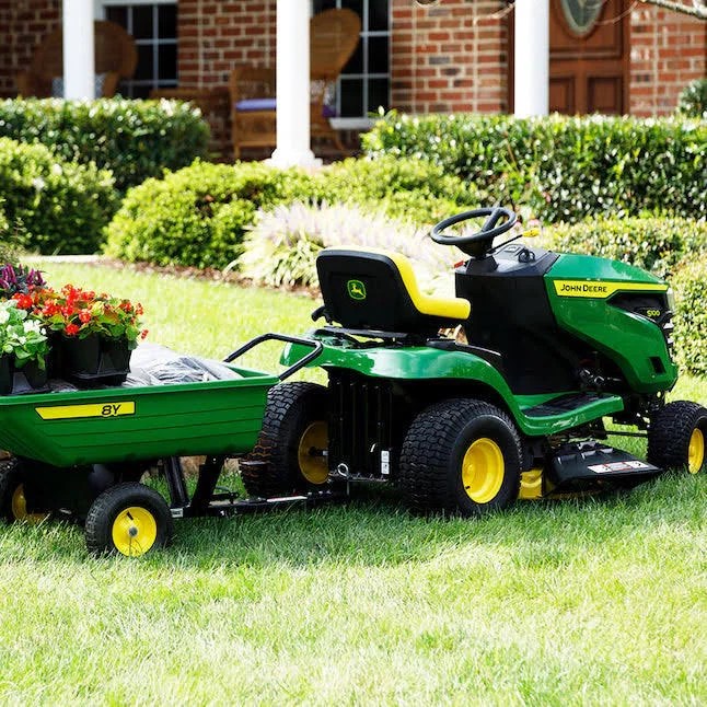 John Deere S100 riding lawn mower with 17.5 HP gas engine and hydrostatic drive, shown outdoors on a grassy lawn.