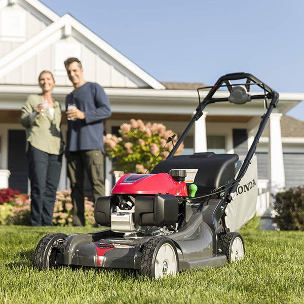 Honda HRX217K5VKA 21-inch gas lawn mower with 187cc engine and 4-in-1 Versamow system, shown with grass clippings and cutting deck